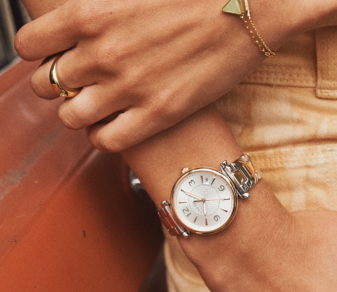 Tight shot of woman with hand in pocket wearing a Fossil watch