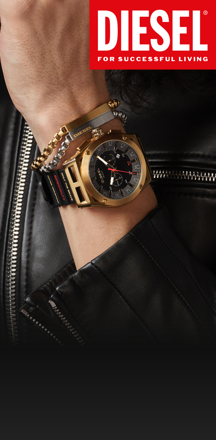 Stylish person wearing silver and gold-tone chain link bracelet with black Timeframe watch by Diesel.