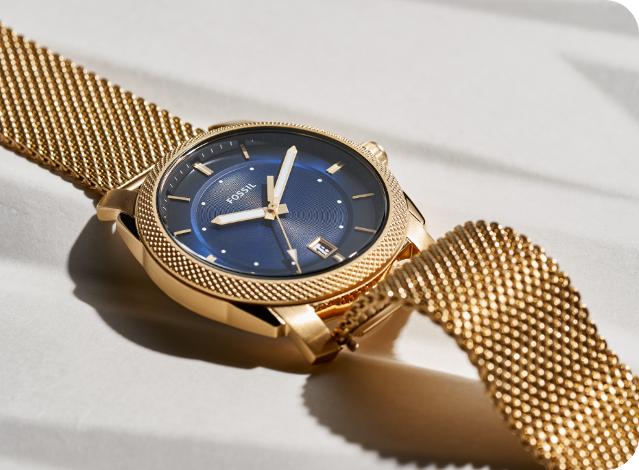 Montre pour hommes Fossil avec un bracelet bronze industriel et un cadran bleu avec des sous-fenêtres profilées bleues.