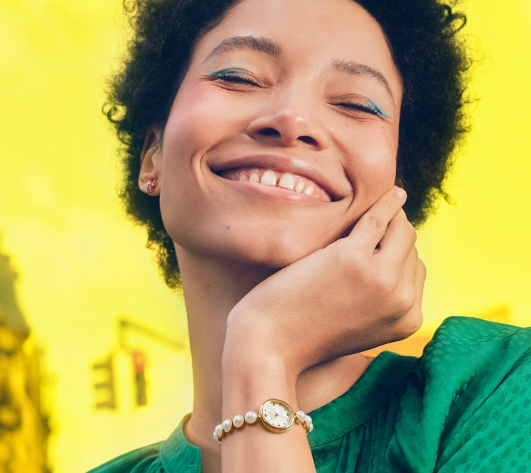 Stylish woman wearing a faux-pearl kate spade new york watch.