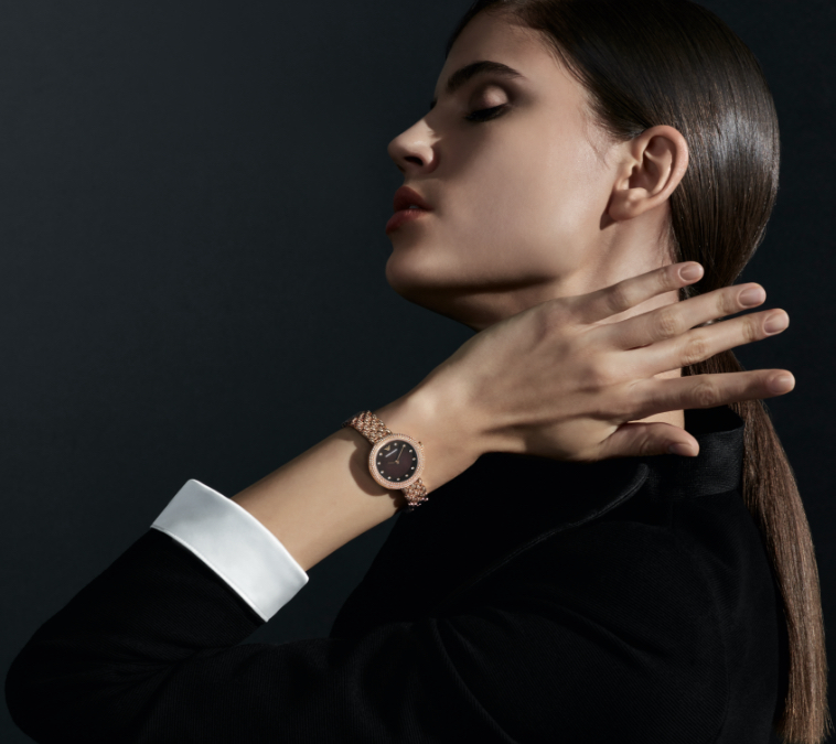 Stylish man wearing navy Emporio Armani watch. Stylish woman wearing striped Emporio Armani watch.