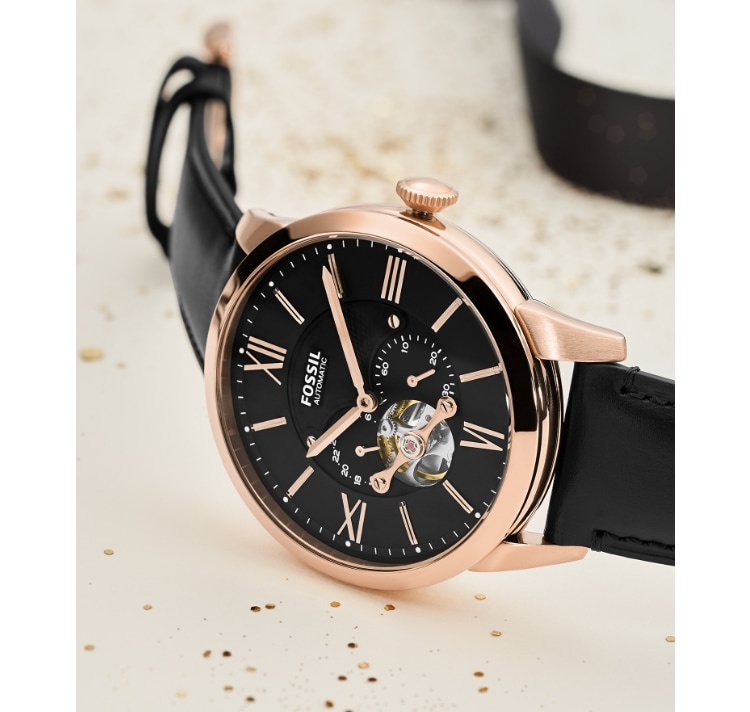A black and rose gold-tone Fossil automatic watch.