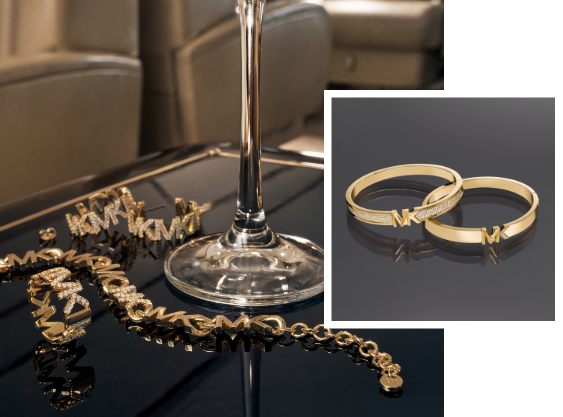 Various Michael Kors jewellery pieces in gold.