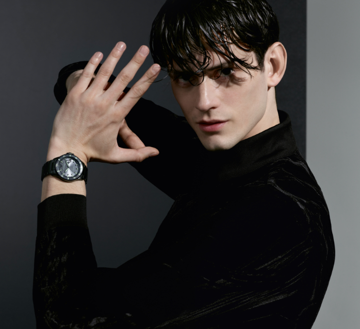Stylish man wearing navy Emporio Armani watch. Stylish woman wearing striped Emporio Armani watch.