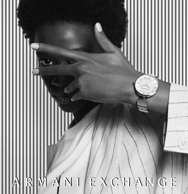Modern, stylish man and woman wearing black and white A|X watches.