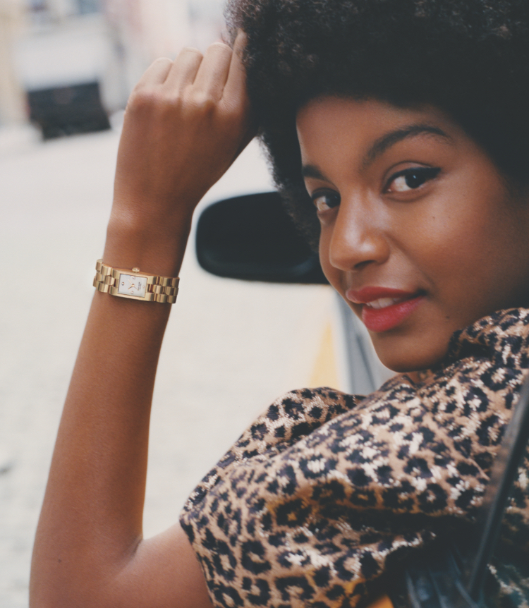 Stylish woman wearing a faux-pearl kate spade new york watch. Stylish woman wearing a faux-pearl kate spade new york watch.