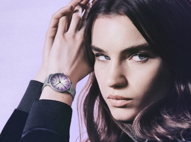 Silver women’s watch with a light purple face.