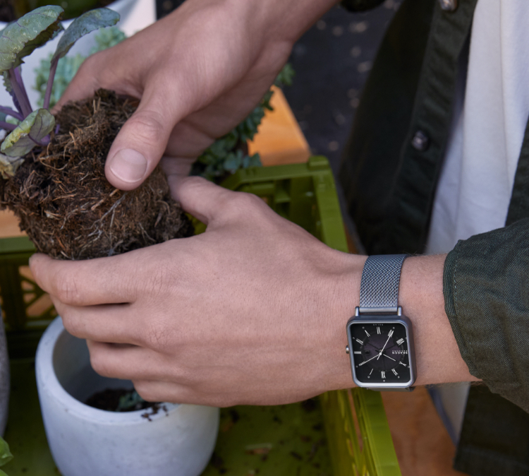 Minimalist-style man wearing Skagen watch featuring brown leather strap. Minimalist-style woman wearing Skagen watch featuring brown leather strap.
