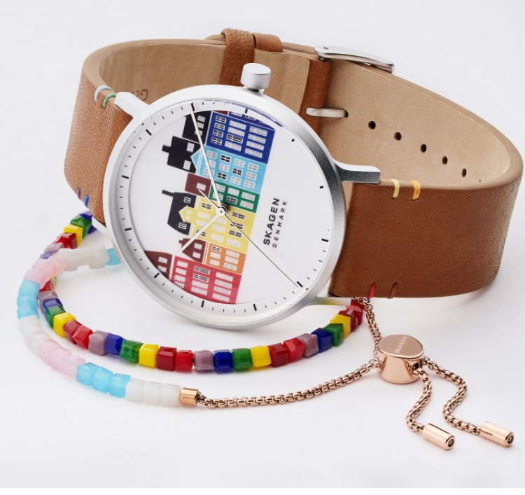 Minimalist Skagen watch featuring Danish-inspired buildings in rainbow colourways. Two beaded bracelets in LGTBQ+ and Transgender Pride flag colours.