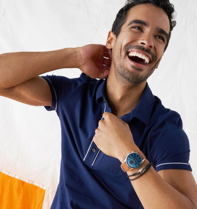 Minimalist-style man wearing brown and blue Skagen watch.