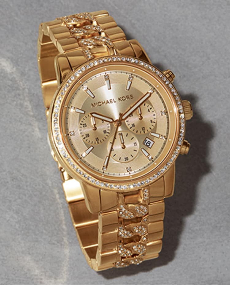 Gold-tone Michael Kors watch featuring glitz.