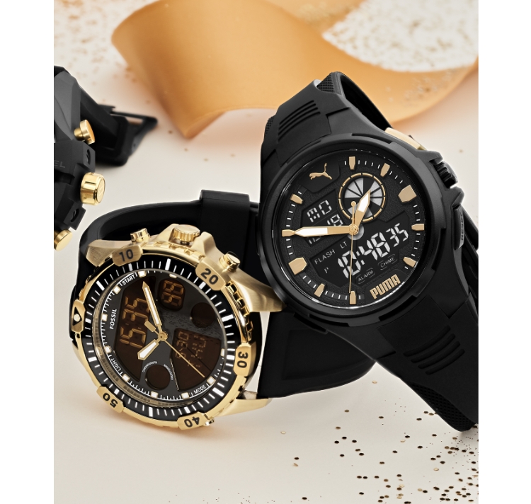 Puma and Fossil digital watches surrounded by ribbon.
