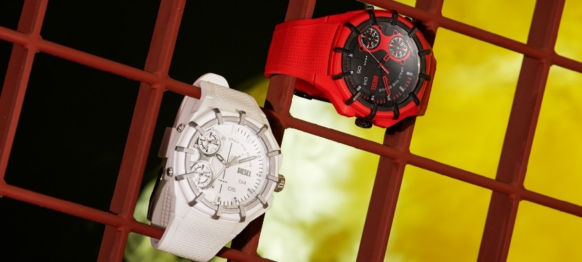 A red and a white watch fastened to a red fence.