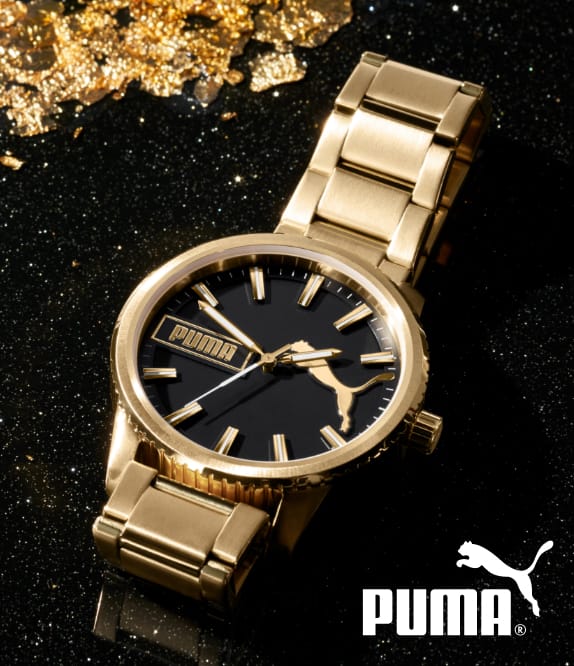 Gold-tone PUMA watch with black dial.